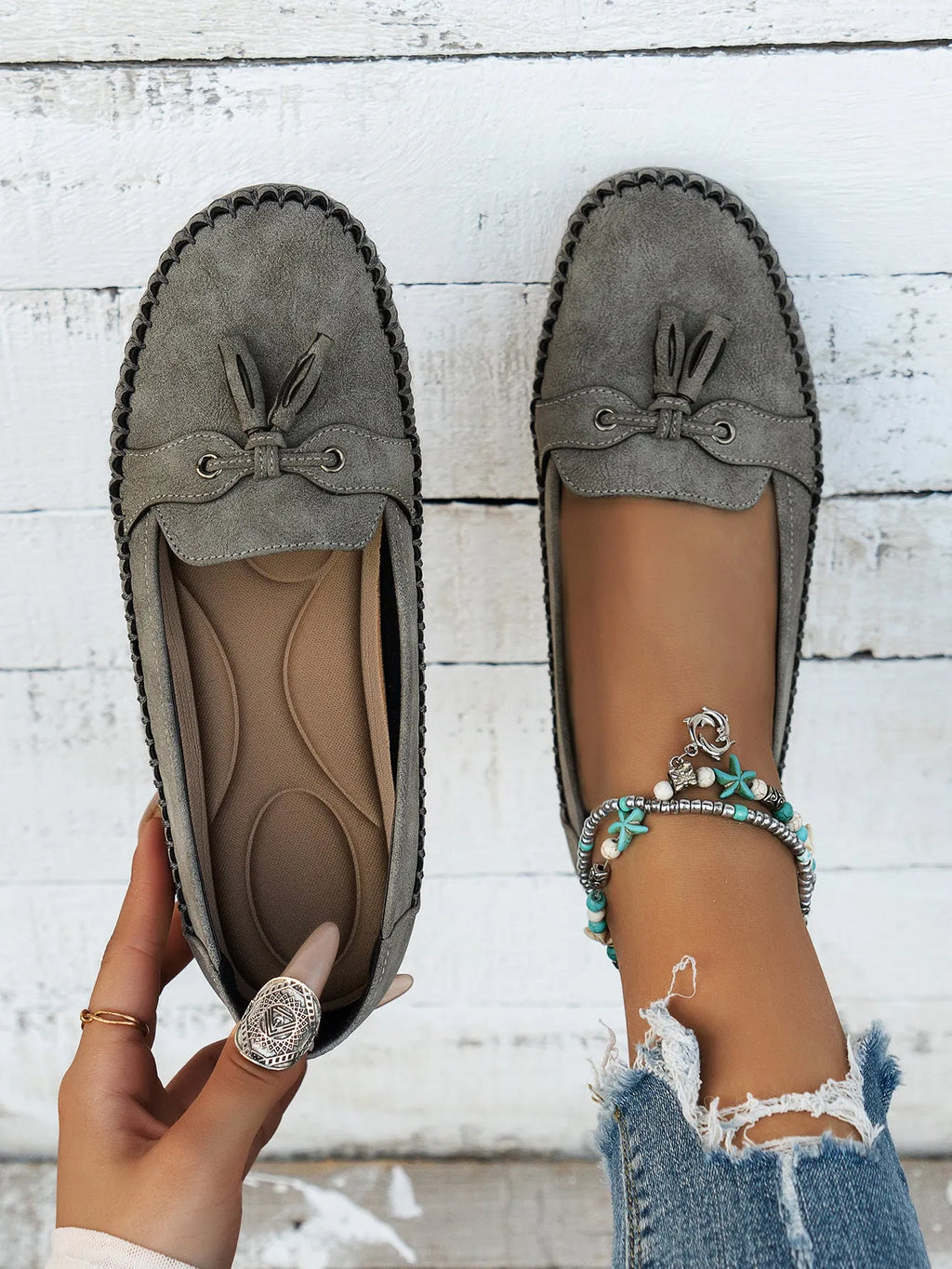 Women's suede flat shoes with a bow, shown in apricot colour, on a white background