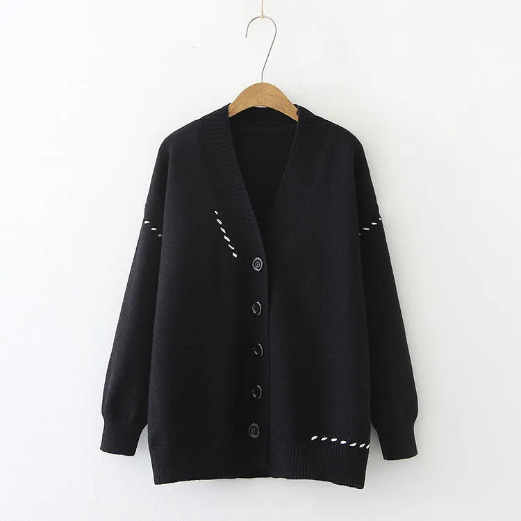 Women's loose-fit knitted cardigan top coat in black or white.