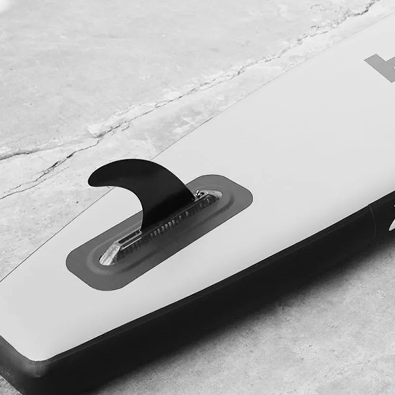 SUP paddle with removable fish fin component showing screw attachment point