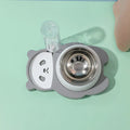 Grey and green panda-shaped elevated pet bowl set with tilted stainless steel bowls and a large automatic water bottle.