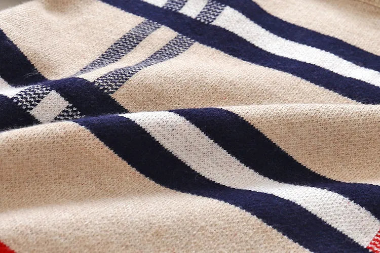 Boys apricot and navy blue plaid jacquard knit sweater with long sleeves on hanger.