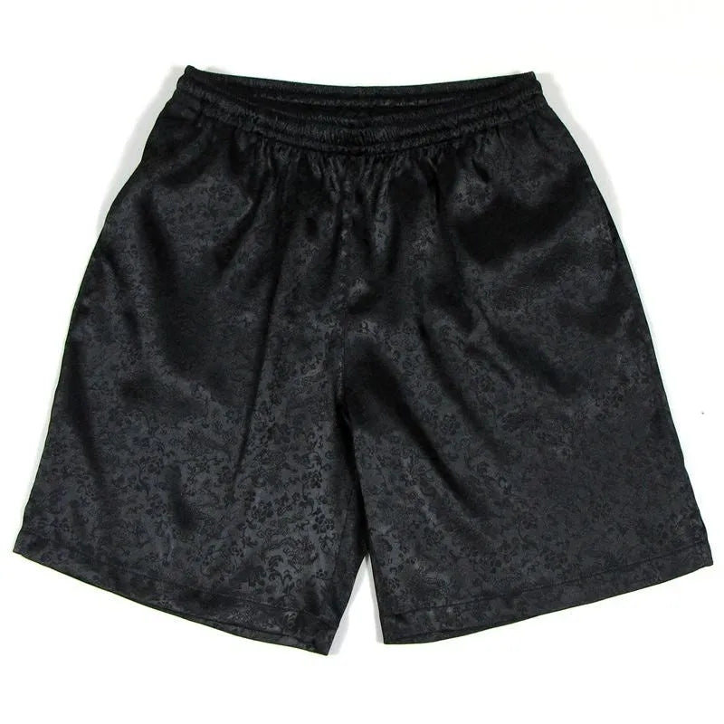Man wearing black traditional tang suit shorts with an elastic drawstring waistband.