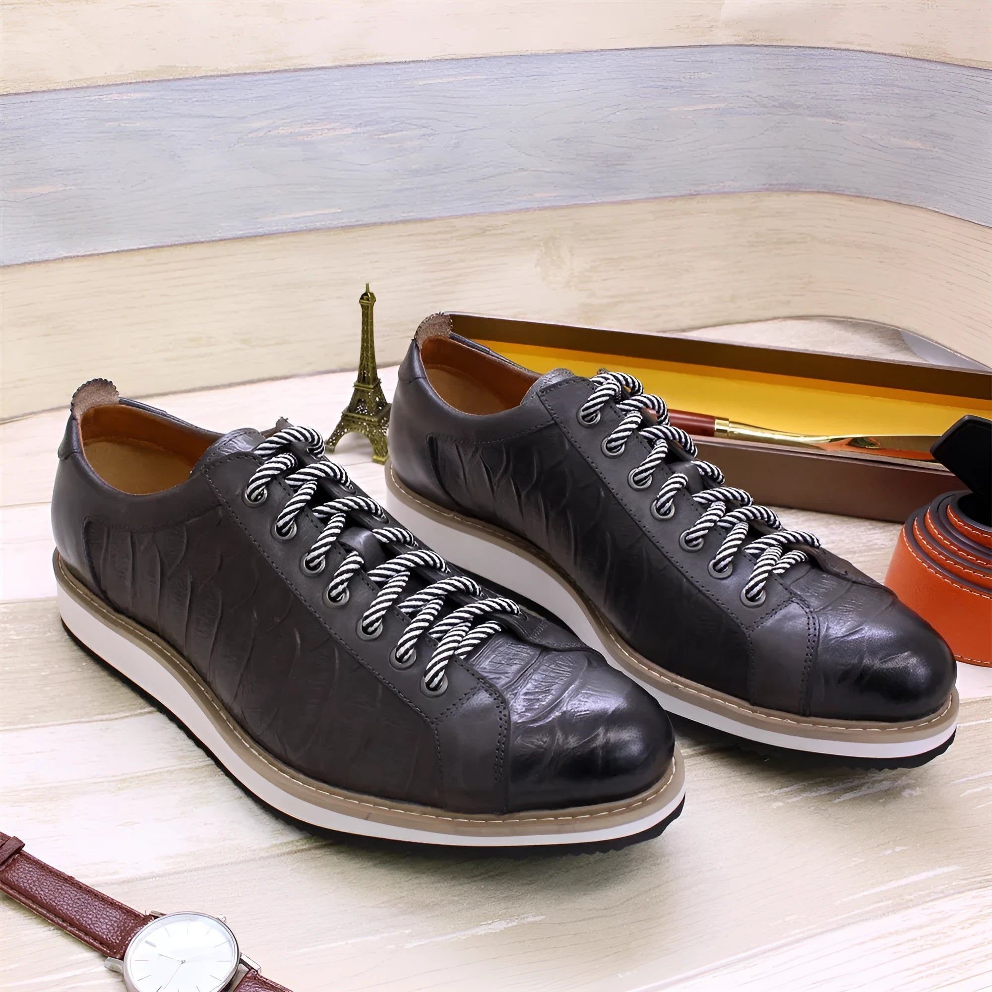 Low tube handmade men's shoes with an embossed pattern, shown in black with front-tie laces.