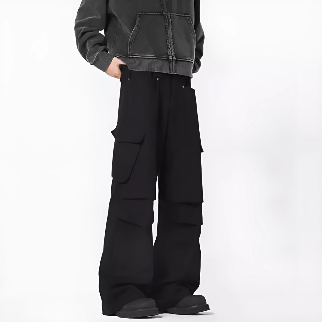 Man wearing black retro high-waist straight-leg casual trousers with a buttoned flap detail.