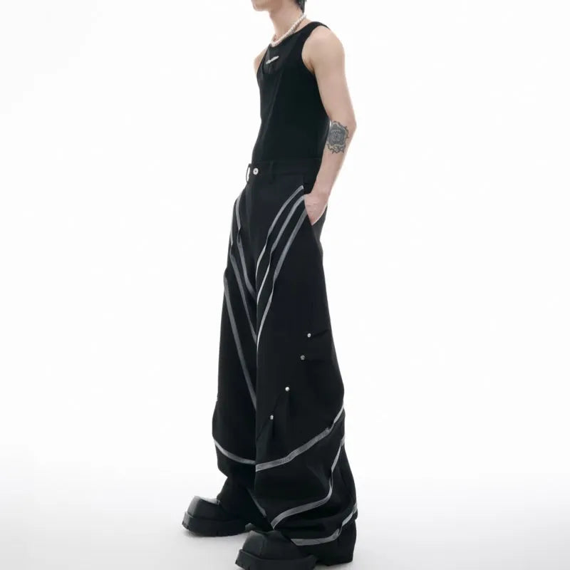 Men's black trousers with three-dimensional cut, metal striped rivets, and pleated detailing