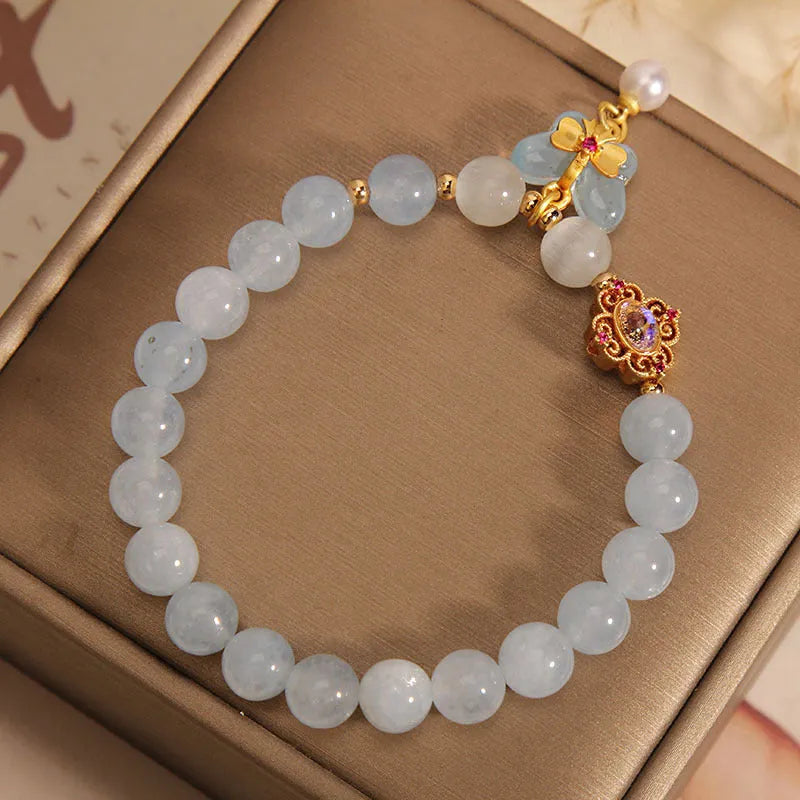 Women's crystal bracelet with aquamarine butterfly pendant and rhinestone detailing.
