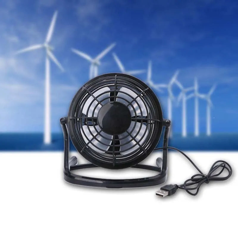 Mini adjustable USB desk fan in black, white, or blue on a workspace next to a laptop.