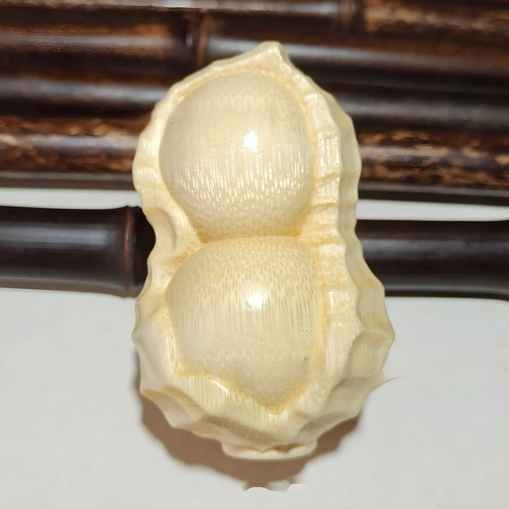 Modern simplicity style solid bamboo carving peanut ornament on a neutral background.