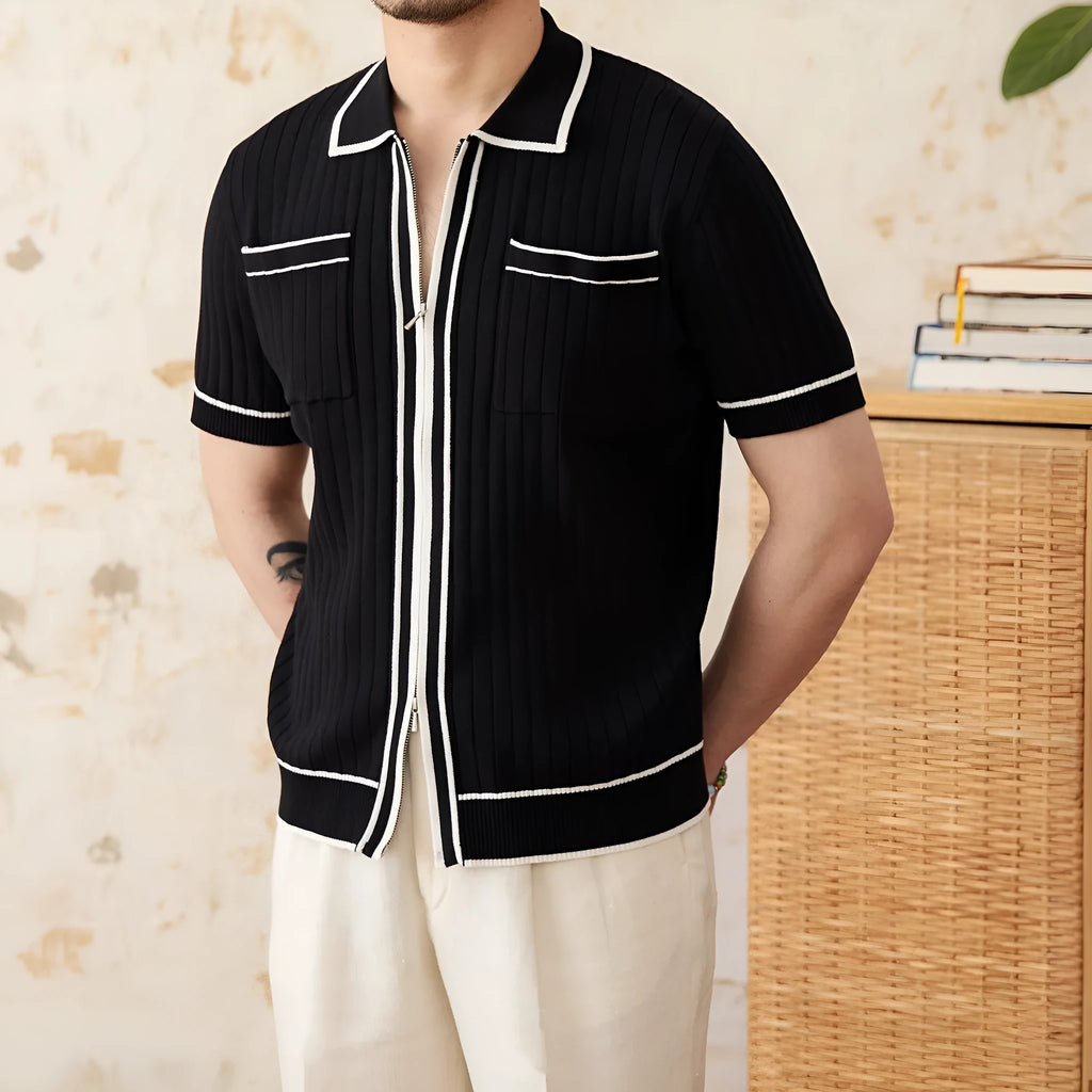A black lapel short-sleeved knit polo shirt laid flat, showing the collar and slim fit.