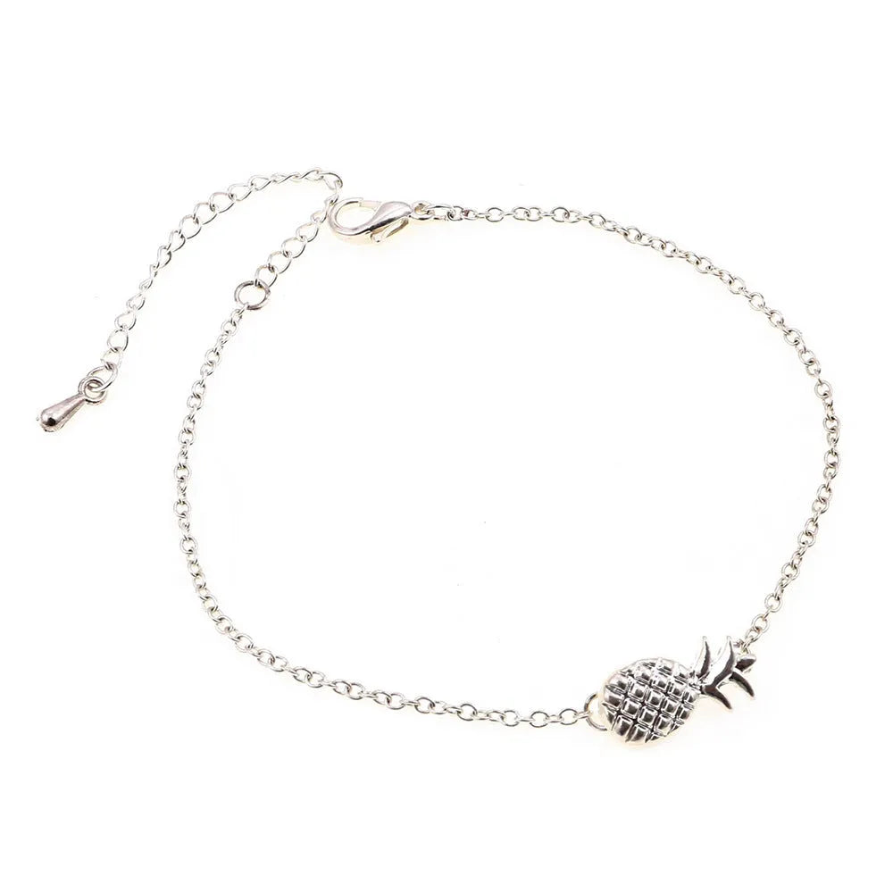 Women's gold tone alloy bracelet with a detailed pineapple charm on an adjustable chain.