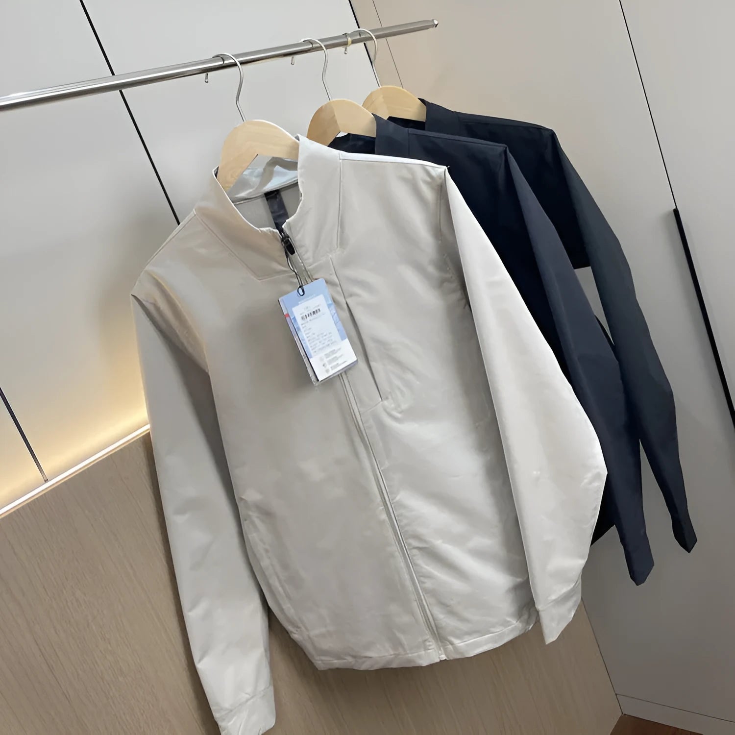Men's stand collar casual jacket in polyester available in black, dark blue, and milky white