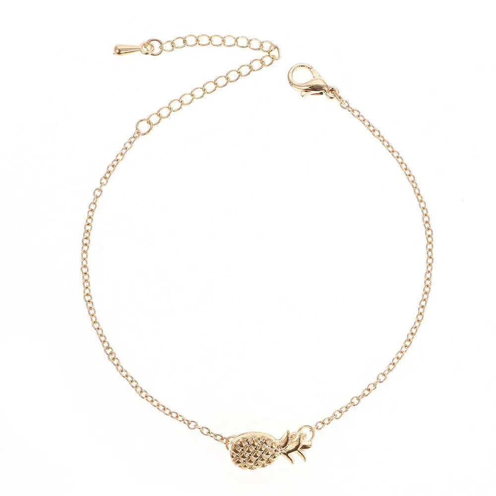 Women's gold tone alloy bracelet with a detailed pineapple charm on an adjustable chain.