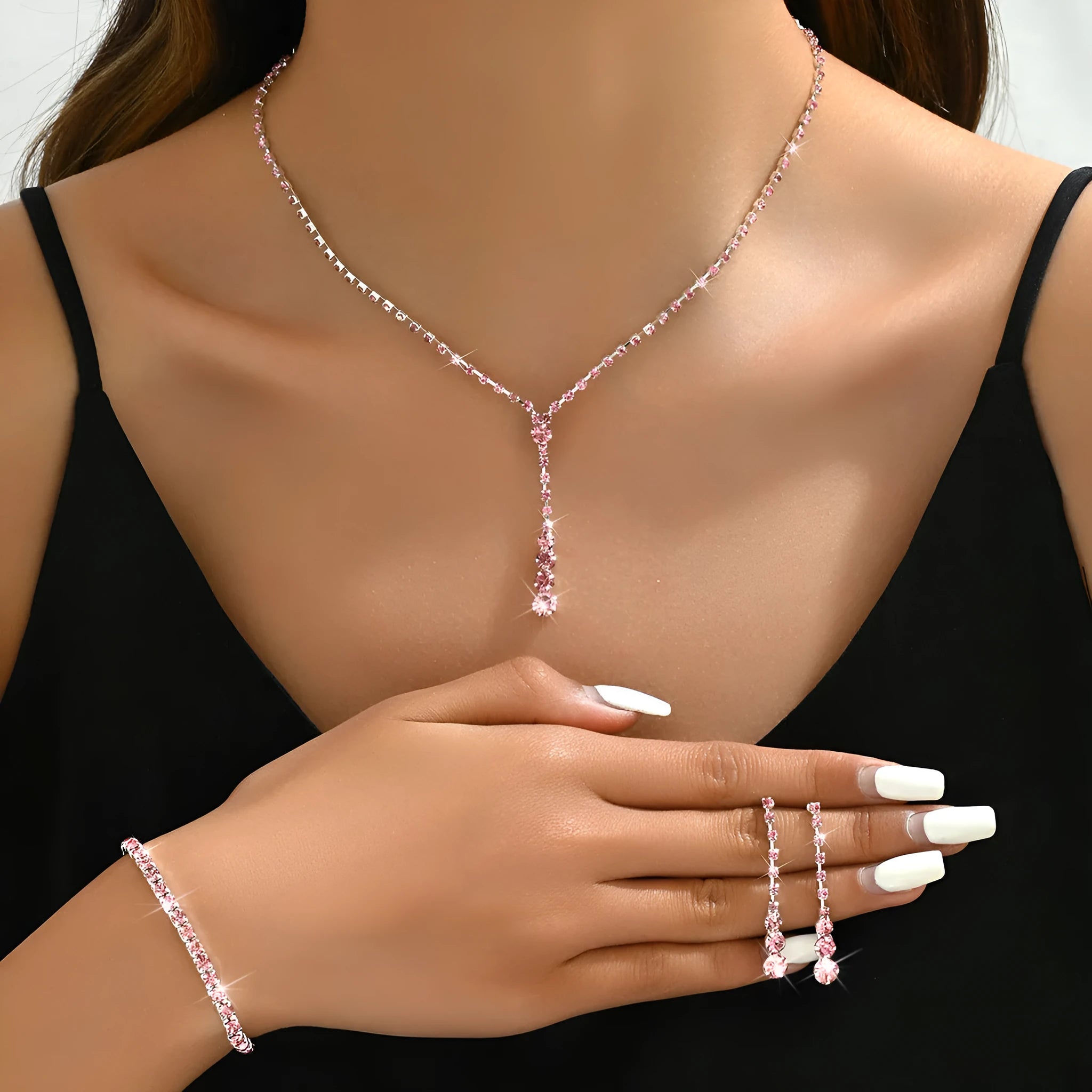 Women's rhinestone jewellery set with elastic bracelet, snake bone chain necklace, and earrings in rose gold finish.