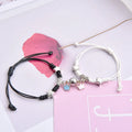 Couple suction bracelet pair showing electroplated alloy construction with crown pendant design