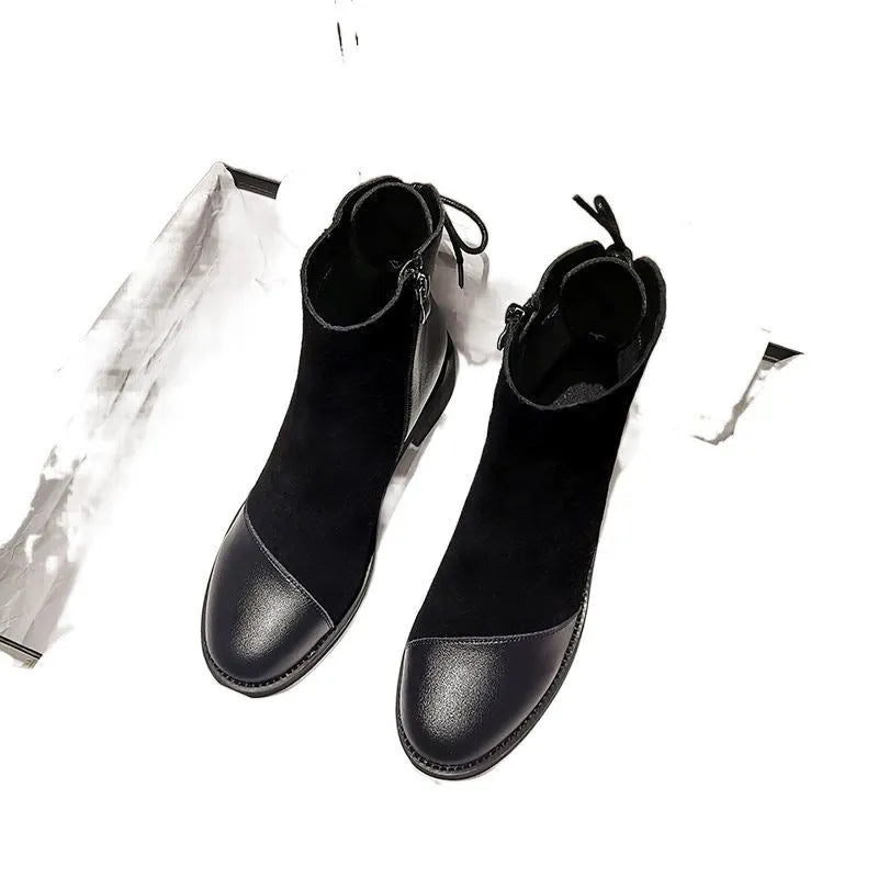 Black women's knee-high Martin boots with side zip and round toe.