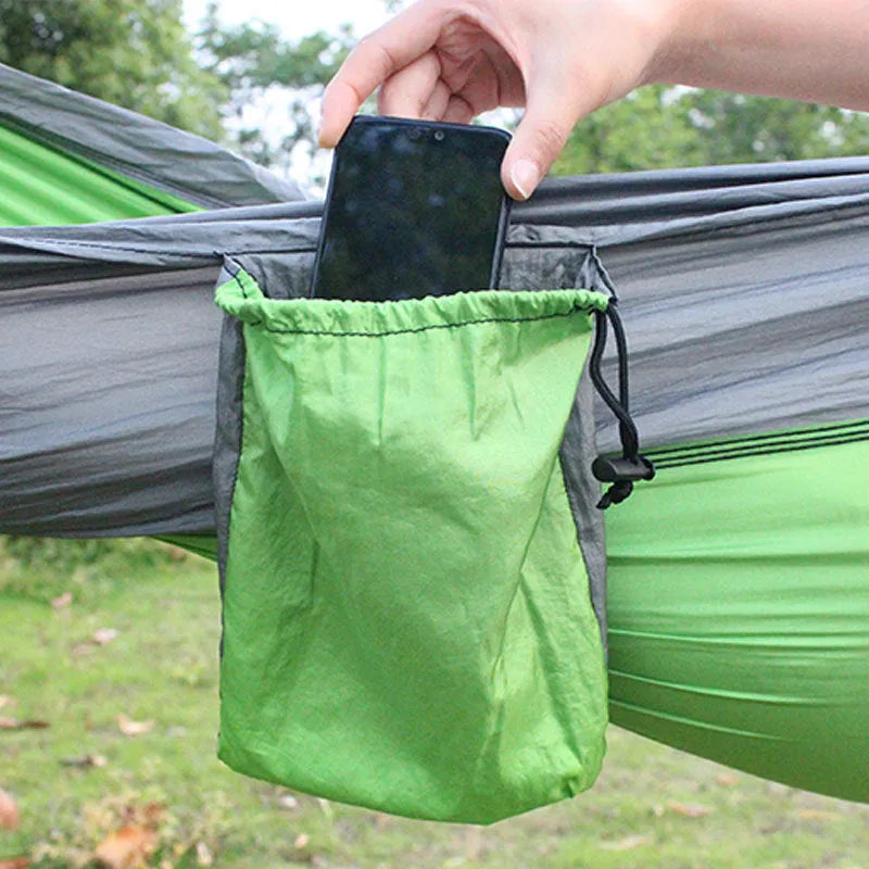 Blue nylon parachute cloth camping hammock hung between trees.