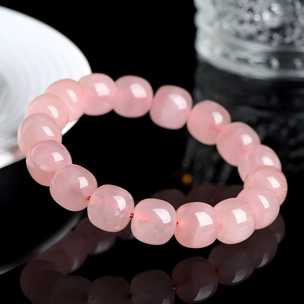Natural pink crystal bracelet with geometric barrel-shaped beads measuring 8-10mm