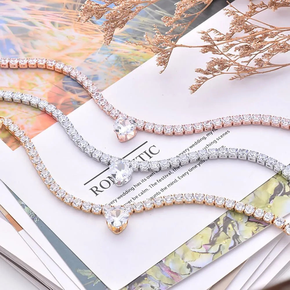 Gold rhinestone heart-shaped decorative collar for cat or dog on a white background.