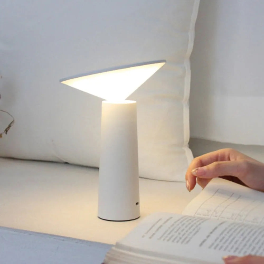 Black USB touch sensor table lamp with adjustable head on a wooden desk