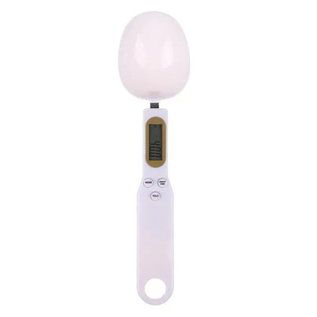 White digital kitchen scale with LCD display and spoon-shaped weighing surface for precise ingredient measurements