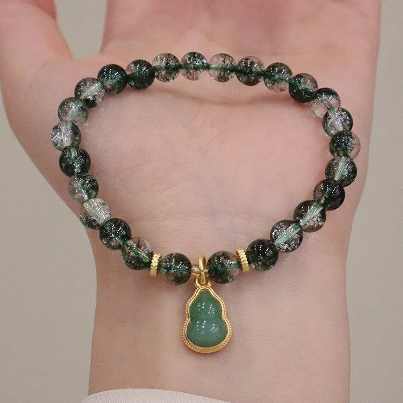 Women's citrine and chorite crystal bracelet with green ghost calabash pendant and heart charm.