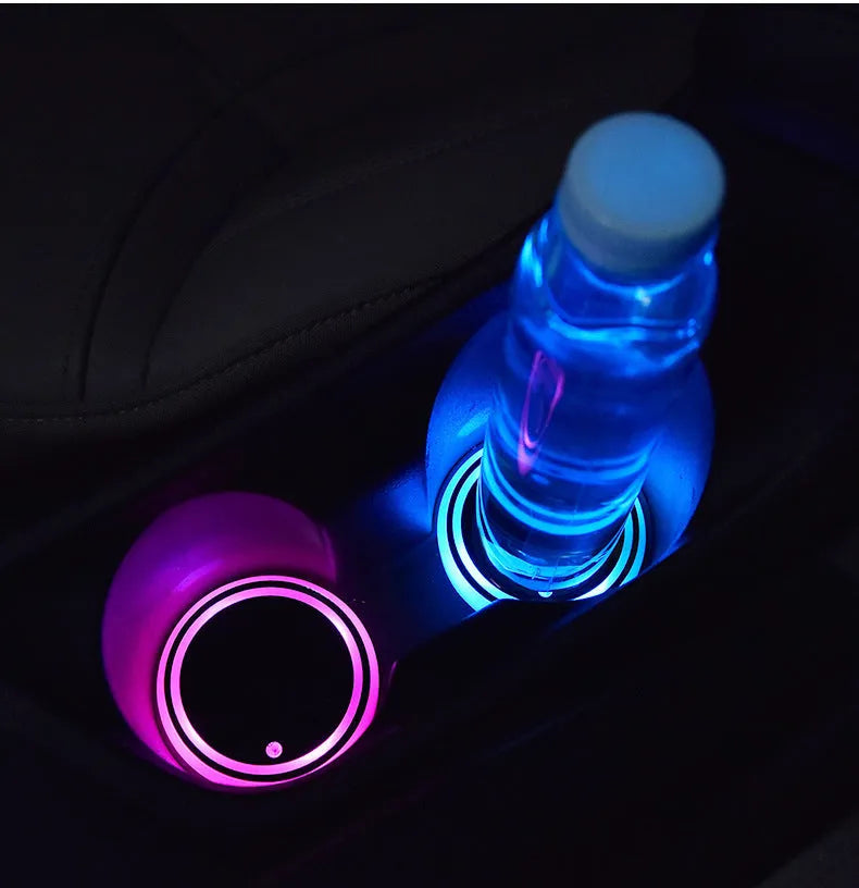 Colourful LED light-up car coaster in a vehicle cup holder, showing multiple light colours.
