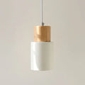 Nordic style solid wood and iron pendant light hanging above a kitchen counter.