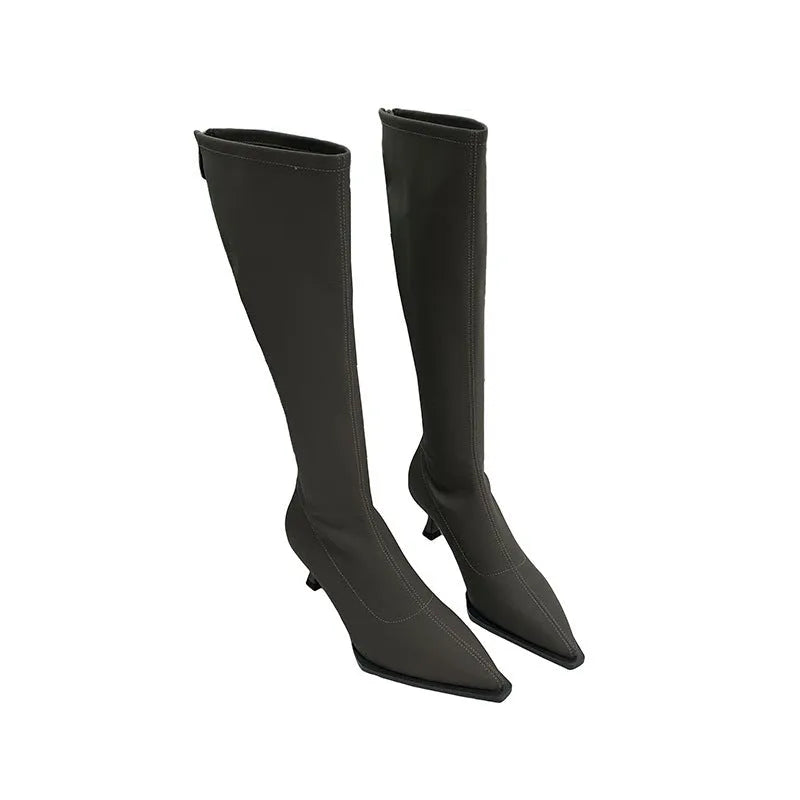 Black pointed toe women's ankle boots with a stiletto heel and a back zipper closure.