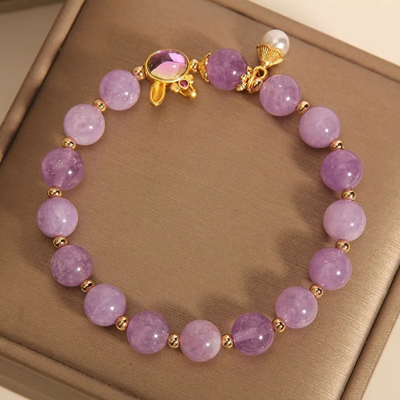 Purplish red mauve jade rabbit head charm on a clear crystal bracelet, Mori style design.
