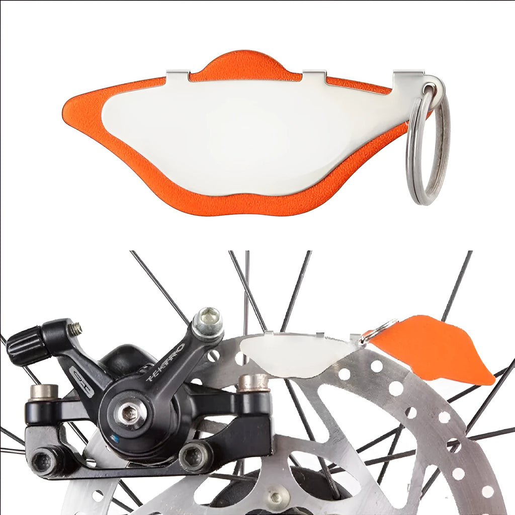 Mountain bike disc brake linings in black and orange with adjustment flap