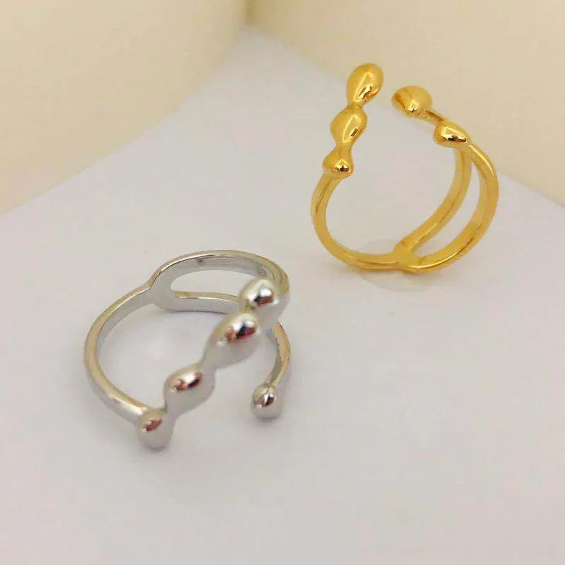 Brass spherical ring with circular design elements in gold or silver finish