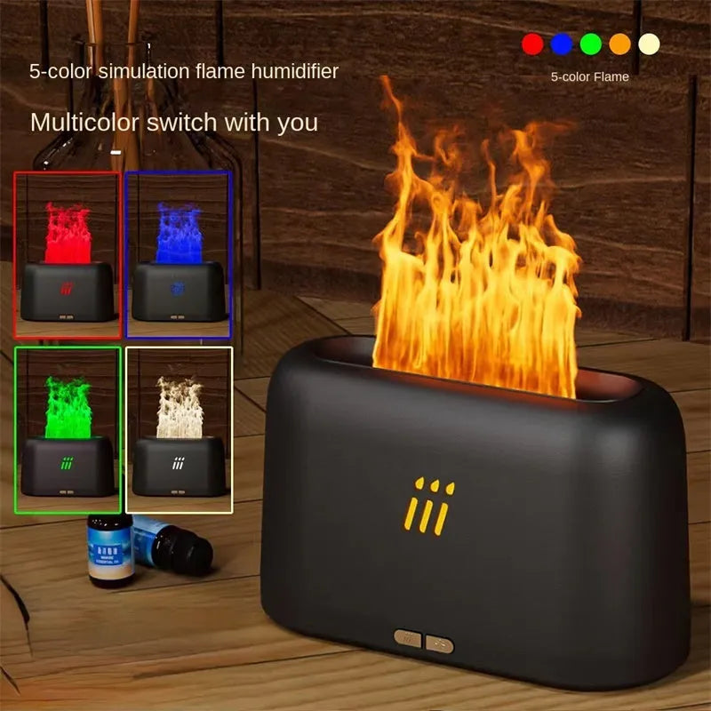 Black and white flame aroma diffuser humidifier with LED lights and remote control on a table.