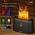 Black and white flame aroma diffuser humidifier with LED lights and remote control on a table.