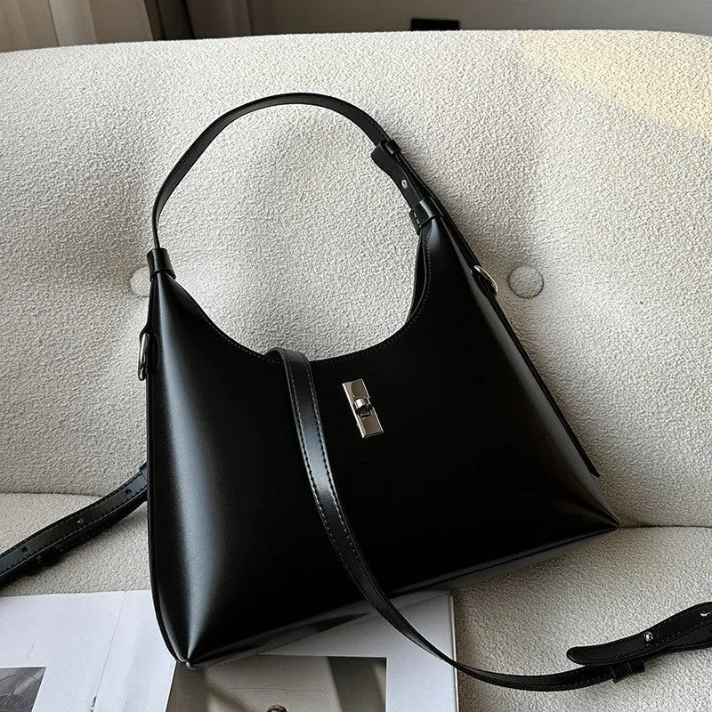 Genuine leather dumpling-shaped crossbody shoulder bag in apricot colour with street-trend details.
