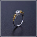 Black gold crystal crown ring on a finger, showing copper metal and decorative stones.