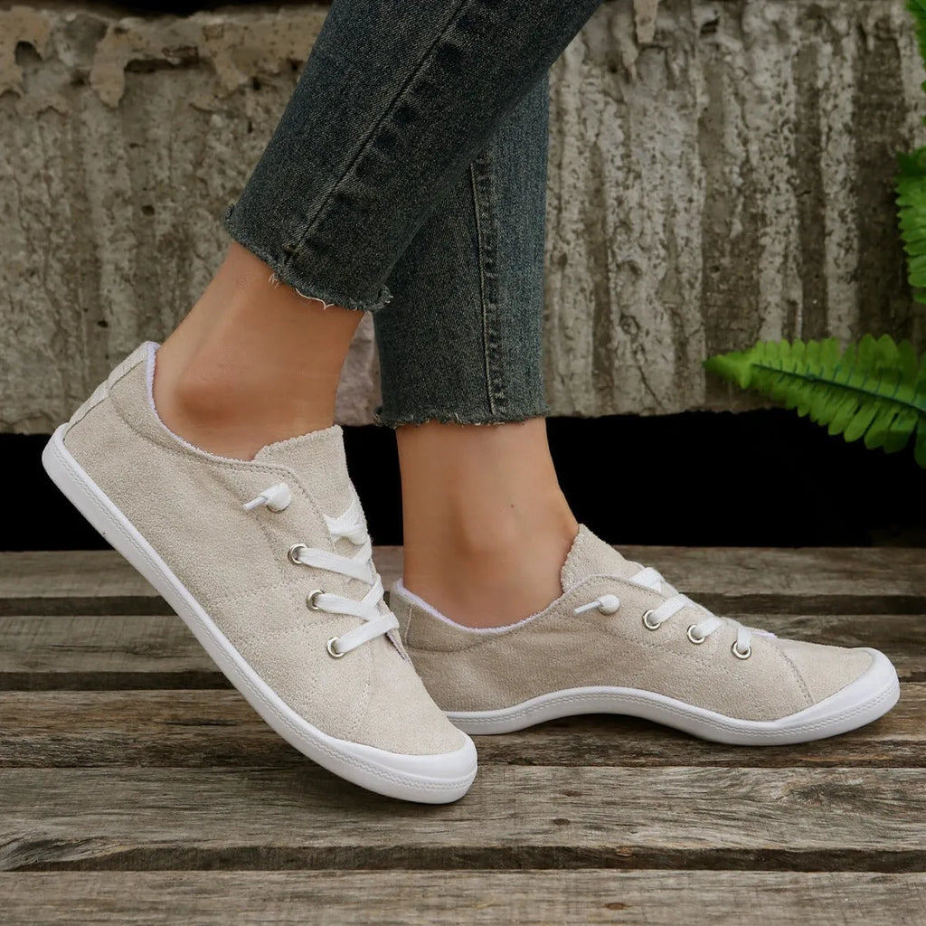 Women's creamy-white fabric casual sneakers with low-top design and rubber sole
