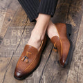 Men's black pointed-toe slip-on shoes with a tassel detail on the low-top PU upper.