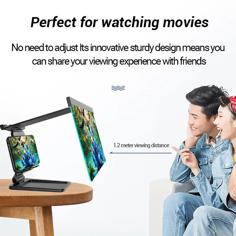 Black foldable mobile phone screen magnifier with a detachable phone holder on a desk.