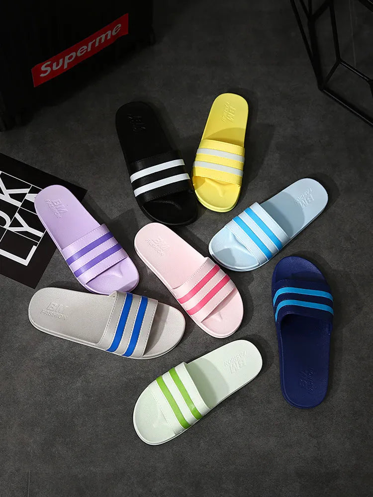 Striped PVC bath slippers in white, black, purple with injection-moulded sole, available in sizes 36-37 to 44-45
