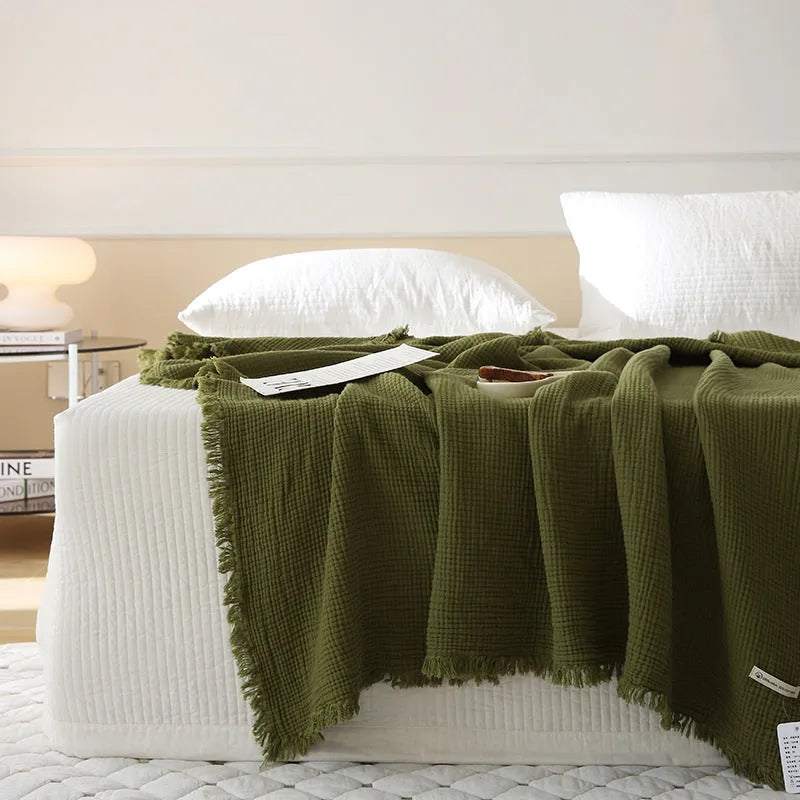 Four-layer gauze cotton blanket with edge tassels in a choice of ten colours and two sizes.