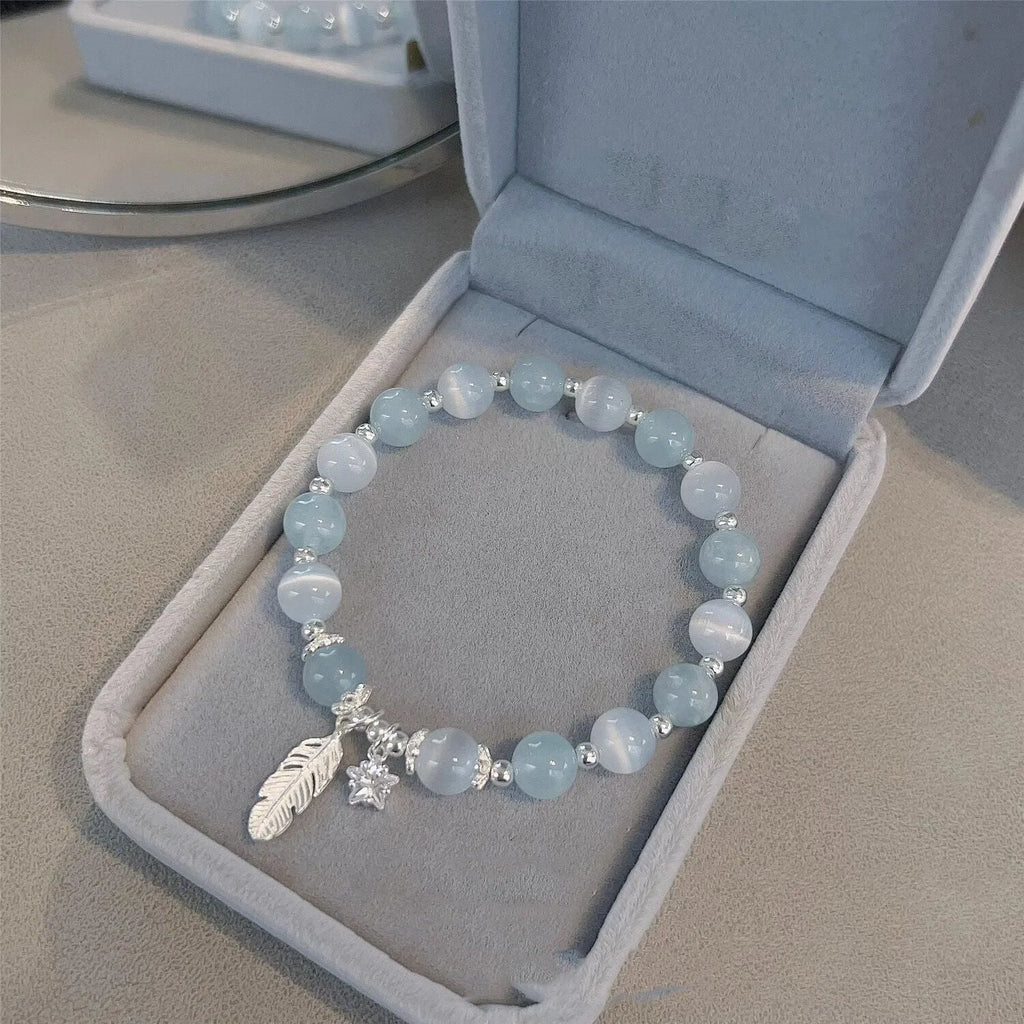 Glass crystal bracelet with coloured glaze in blue moonlight colour showing text modelling and eight-point star detail