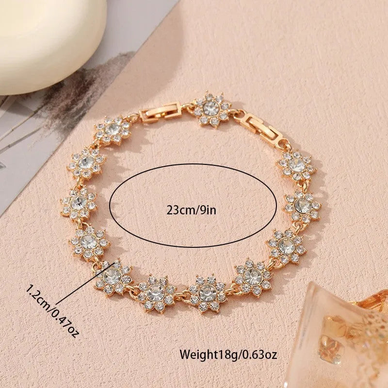 European style electroplated bracelet with flower-shaped coloured gemstones on a metallic chain.