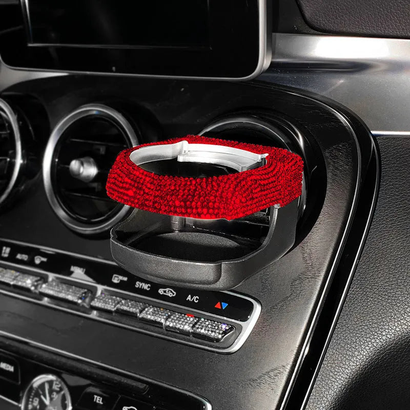 Diamond-decorated car cup holder bracket mounted on air vent in blue rhinestone finish