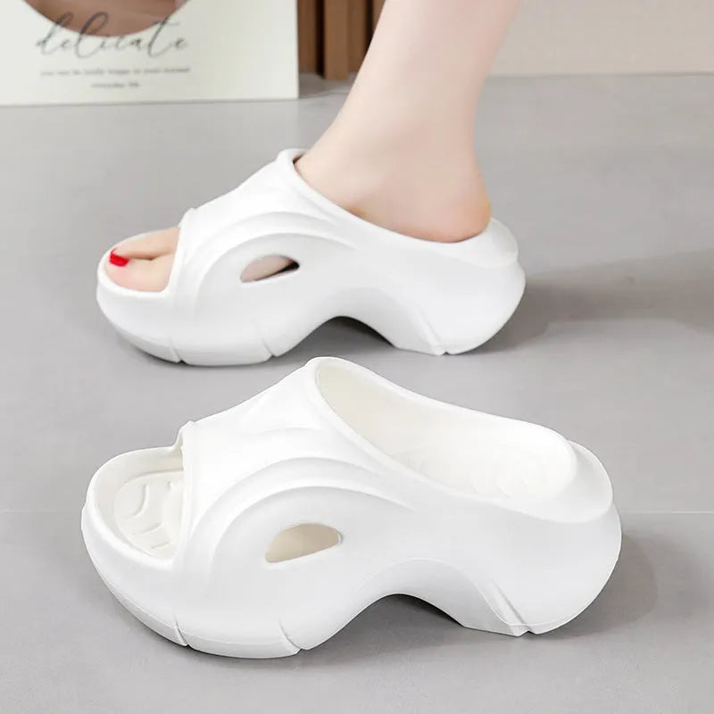 Women's white thick-soled EVA slippers with round toe for beach wear.