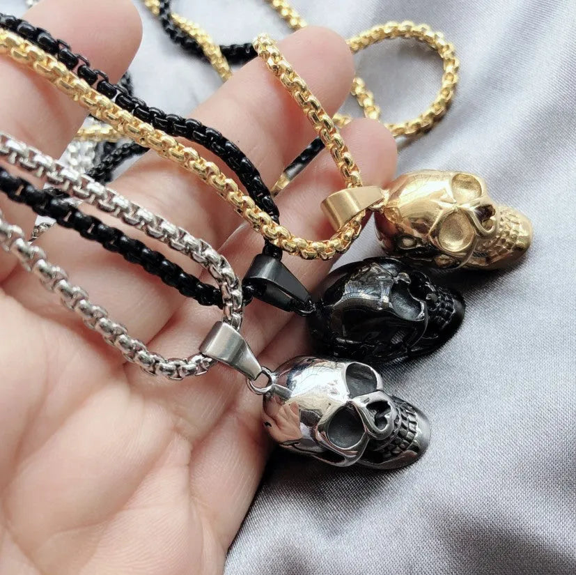 Halloween skull necklace in alloy and stainless steel with gold colour option on a black background