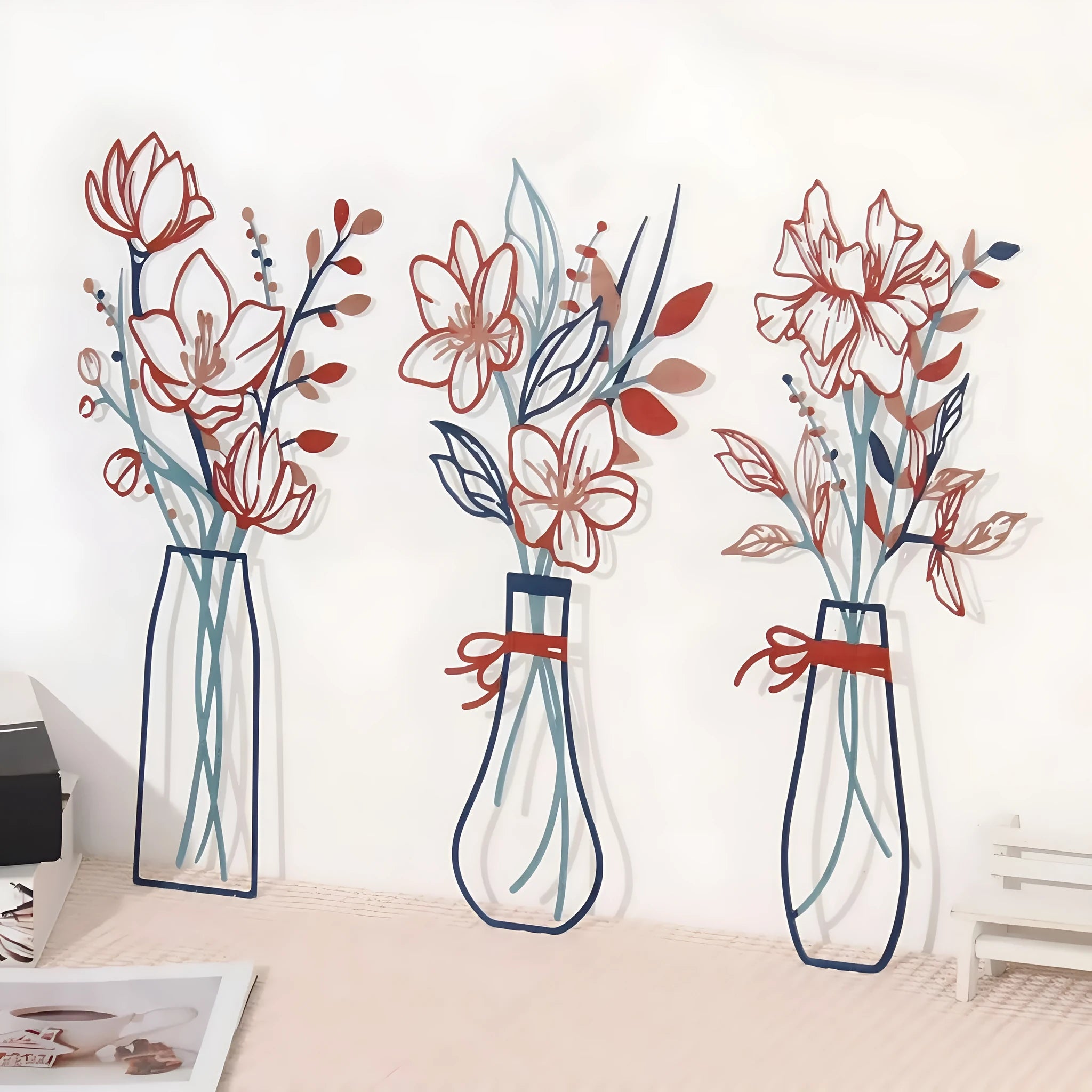 Three metal wall art pieces featuring floral vase designs in modern farmhouse style