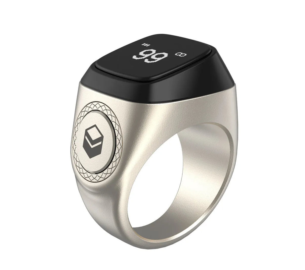 Zikr1 silver smart ring on a finger showing its OLED display and single button.