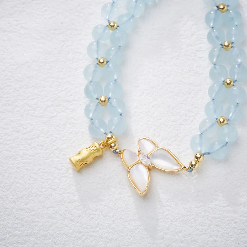 Women's aquamarine woven bracelet with butterfly design and 6mm stone beads