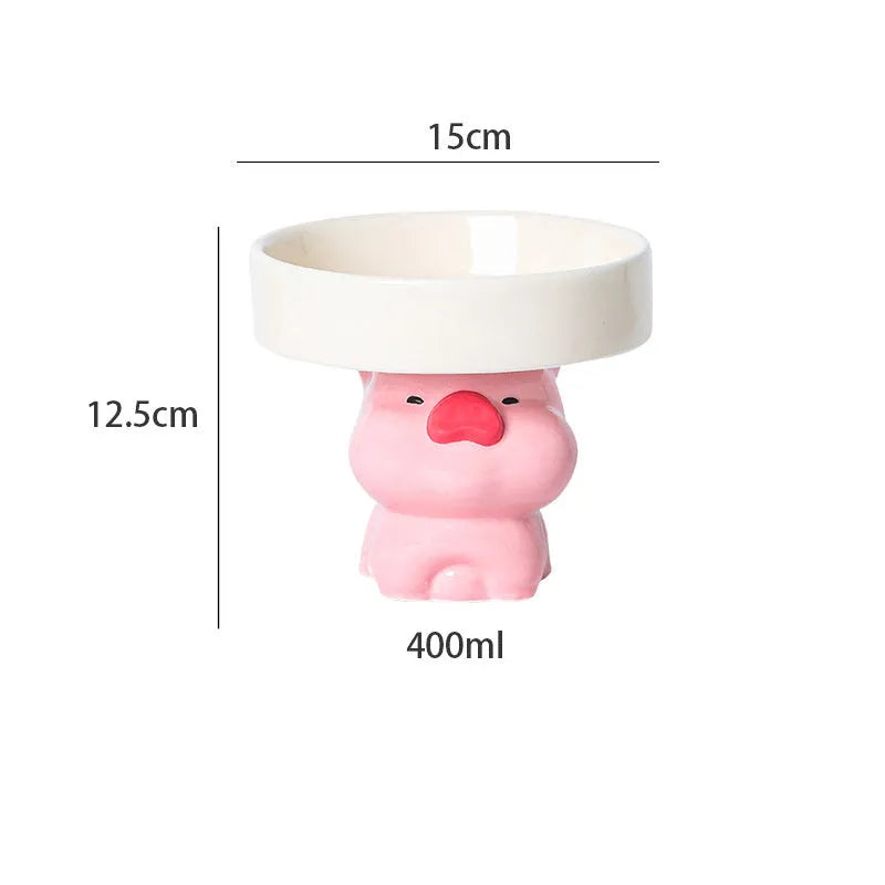 White ceramic raised cat bowl with a bear design, showing its elevated stand and wide feeding dish.