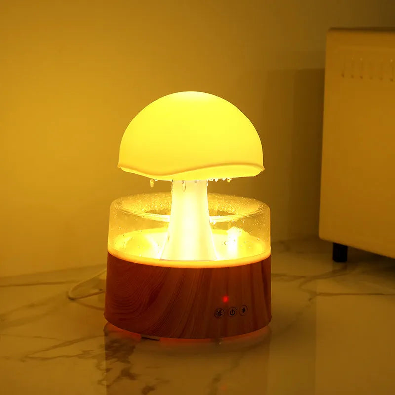 White cloud-shaped humidifier with simulated falling raindrops and coloured LED lighting